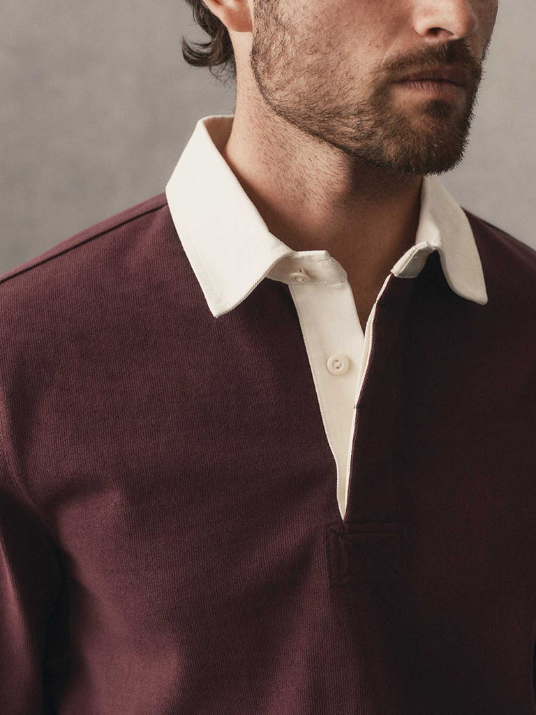 man wearing a burgundy polo with a white collar