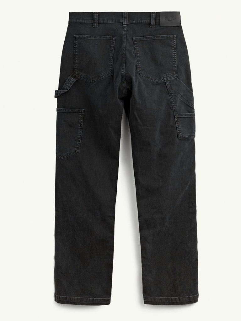 Black cargo pants shown from the back, featuring a straight-leg fit, belt loops, rear patch pockets, and side cargo pockets, photographed against a light off-white background.