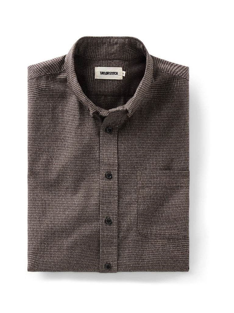 A folded brown houndstooth button-down shirt 
