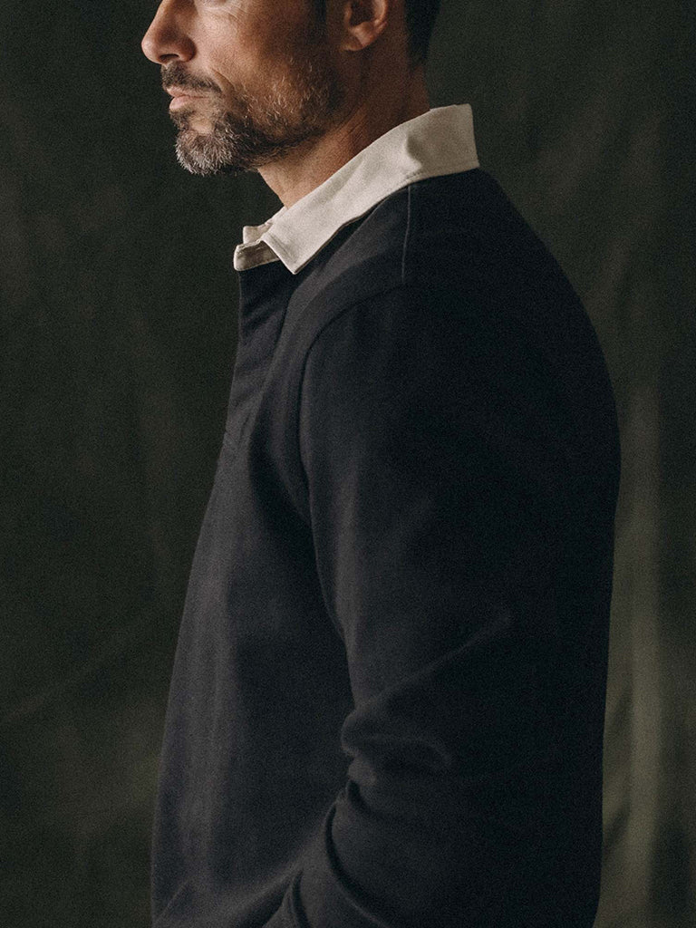 profile of a man wearing a black polo