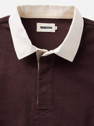 Close-up of a burgundy polo shirt with a contrasting off-white collar