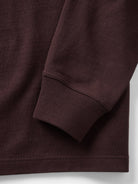 Close-up of a burgundy shirt showing the texture and cuff 