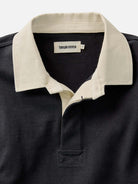 Close-up of a black polo shirt with a contrasting white collar 