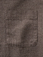 Close-up of a brown and beige houndstooth front pocket 