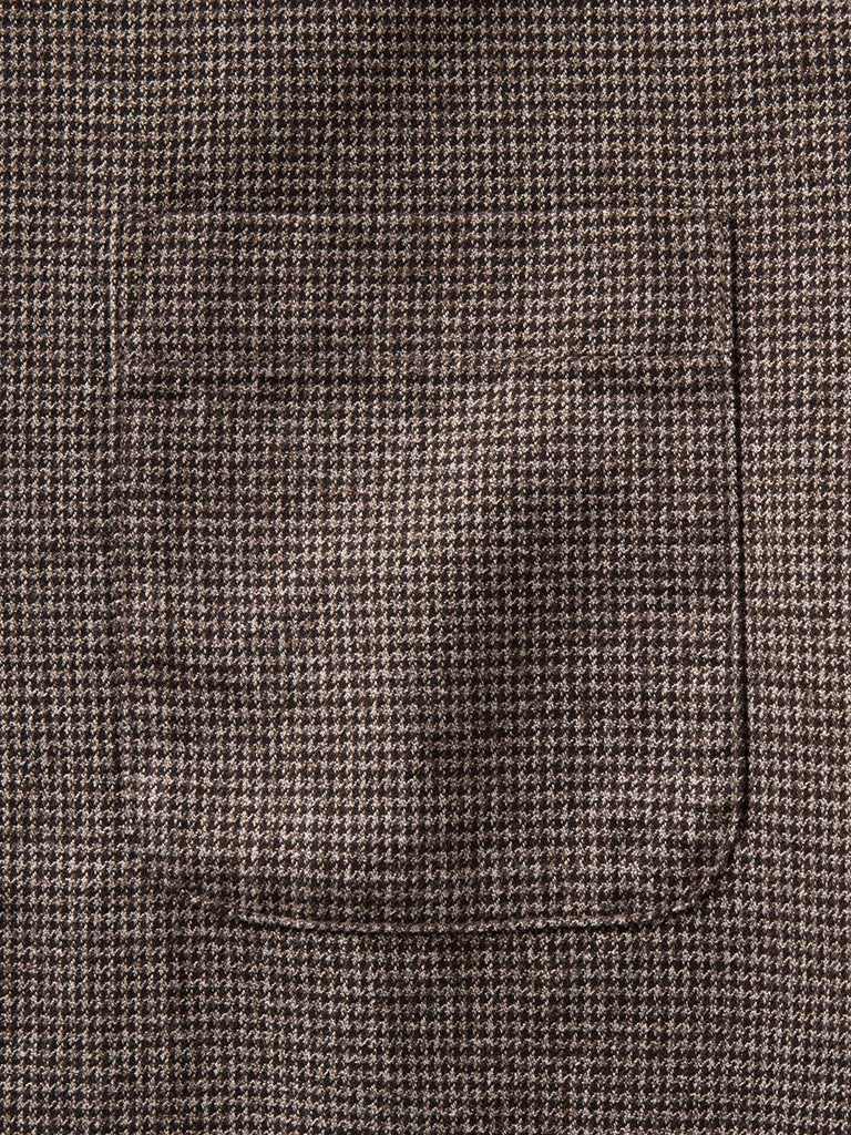 Close-up of a brown and beige houndstooth front pocket 