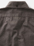 Close-up of a brown and black houndstooth shirt collar 