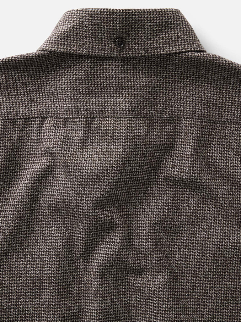 Close-up of a brown and black houndstooth shirt collar 